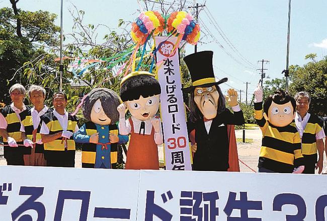 着ぐるみの鬼太郎などと共にくす玉を割り、水木しげるロード誕生３０周年を祝う関係者＝境港市大正町、駅前公園