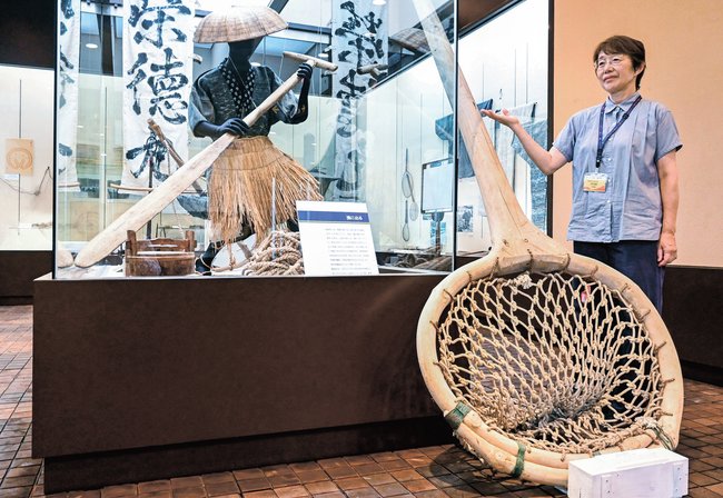 漁で使われた道具を紹介する丹羽野輝子さん＝松江市鹿島町名分、鹿島歴史民俗資料館