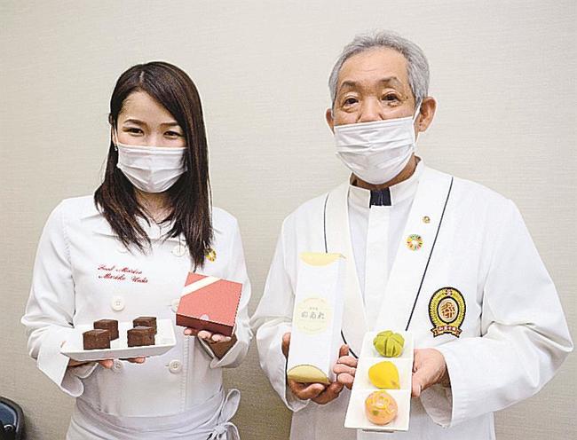 「彩雲堂のあれ」を持つ大江克之さん（右）と上田まり子さん＝松江市末次町、市役所