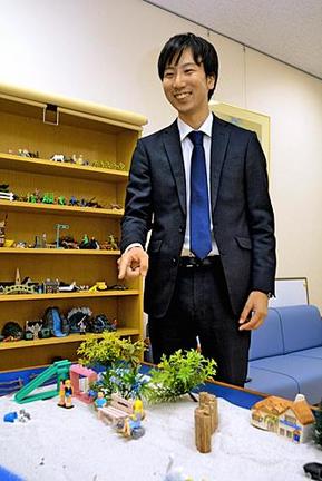 子どもの心理状況を観察するのに利用するフィギュアを紹介（しょうかい）する家裁調査官の柿雅人さん。人の人生に関わることを生涯の仕事としてやっていきたいと話す＝松江市母衣町、松江家庭裁判所