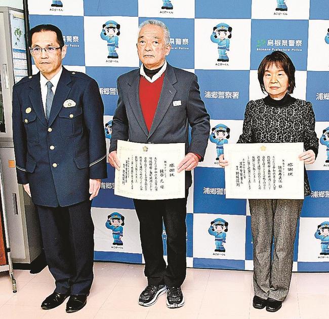 感謝状を受け、野坂保則署長（左）と記念写真に納まる鏡谷元さんと寿美江さん＝島根県西ノ島町浦郷、浦郷署