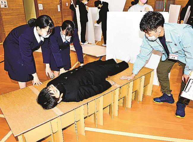 段ボールベッドの寝心地を確かめる生徒〓(?)江津市桜江町川戸、桜江中学校