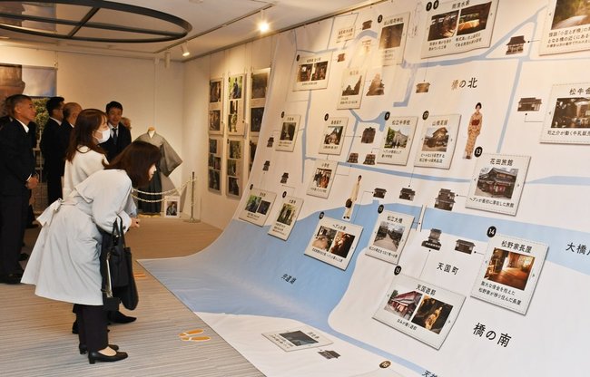 「ばけばけ」で描かれるスポットに見入る来場者=松江市殿町、カラコロ工房