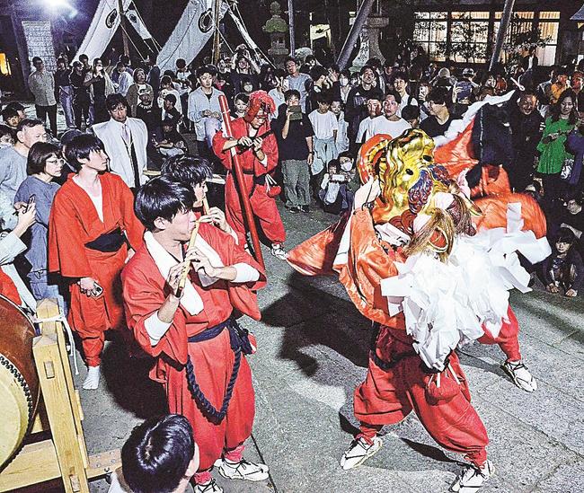 大勢の住民が見守る中、力強く麒麟獅子舞を演じる若者たち＝鳥取市賀露町北１丁目、賀露神社