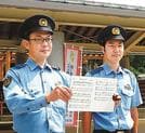 作曲した歌の楽譜を見せて紹介する鎌谷宗和巡査部長（左）と、作詞を担当した松浦裕二巡査部長