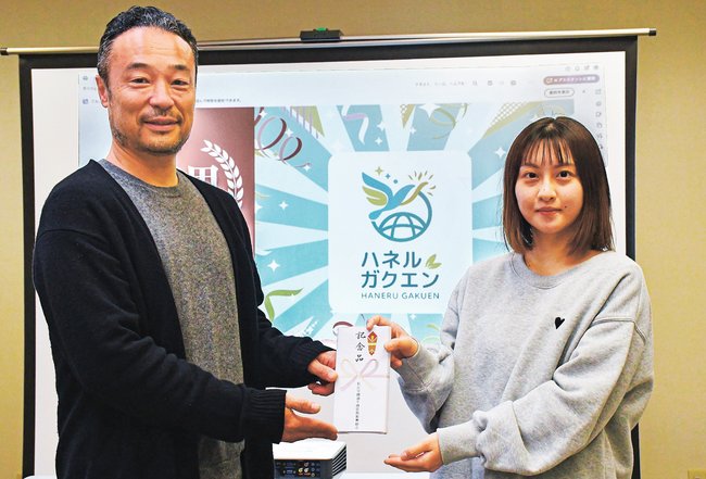 藤崎優衣さん(右)に記念品を手渡す坂田健一理事長=松江市西川津町、川津公民館