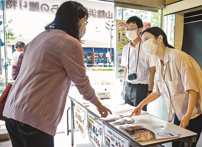 地元の人と交流しながら接客する記者（右）＝大分県日田市元町、にこにこ交流館