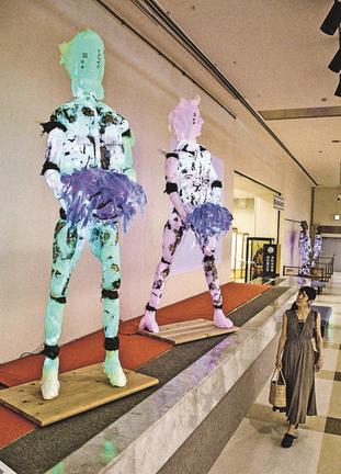 岡野元房さんの和紙彫刻作品「大切な物を運ぶ２人」を見る来館者＝鳥取市覚寺、渡辺美術館