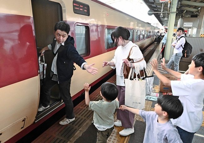親族に見送られながら列車に乗り込む帰省客＝松江市朝日町、ＪＲ松江駅