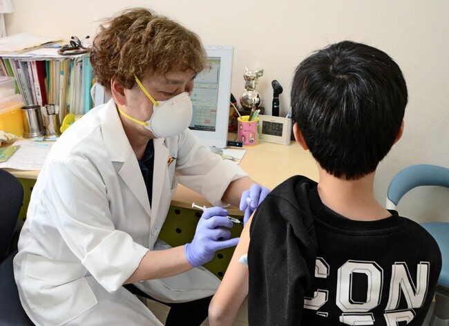 新型コロナウイルスワクチンを受ける子ども（右）＝松江市東朝日町、くらたこどもクリニック