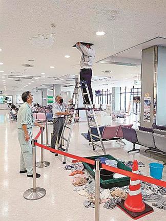 漏水した天井を確認する関係者＝６日午前１１時４５分ごろ、出雲市斐川町沖洲、出雲空港