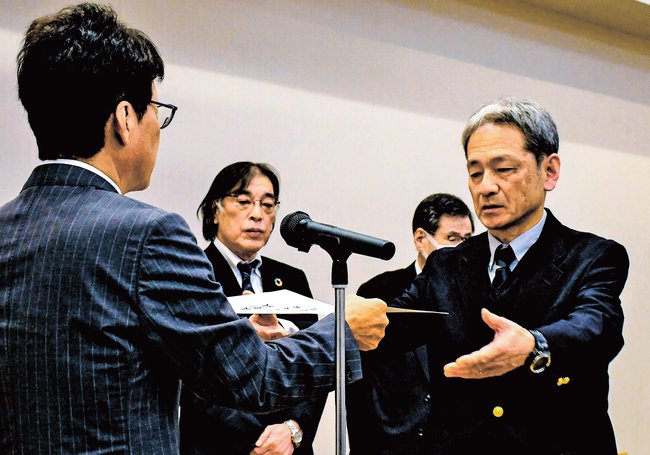 長野真久学院長（左）から表彰を受ける講師＝松江市千鳥町、ホテル白鳥