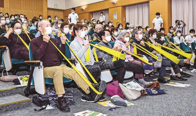 ゴムバンドを使った運動を体験する参加者＝出雲市姫原４丁目、島根県立中央病院