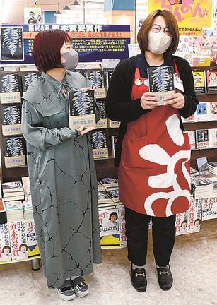 特設コーナーの前で交流する千早茜さん（左）と大田店の文芸担当者＝2023年4月、大田市大田町、ブックセンタージャスト大田店