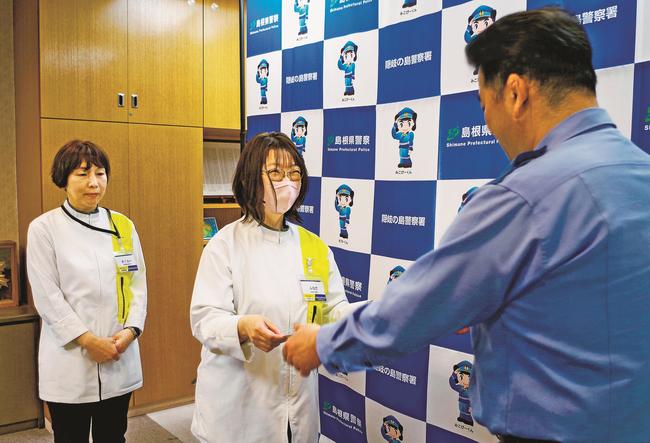 上野訓生署長（右）から感謝状を受け取る船田明美さん（中央）と桜井勝美さん＝島根県隠岐の島町西町、隠岐の島署