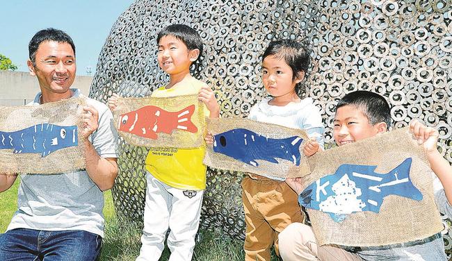 完成させたオリジナルのこいのぼりを披露する親子＝浜田市野原町、市世界こども美術館