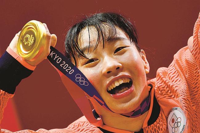 女子フェザー級で優勝し、金メダルを手に笑顔の入江聖奈＝両国国技館