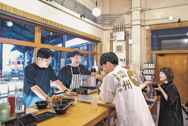 イベントに向けて準備する出店者ら＝出雲市大社町杵築南、一畑電車出雲大社前駅