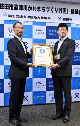 登録証を手にする、国土交通省中国地方整備局の新宅幸夫河川部長（左）と山本浩章益田市長＝益田市常盤町、市役所
