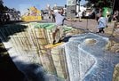 
          
ロシアのモスクワにある公園で、地面にえがいただまし絵の上に立ってポーズをとる作者（ロイター＝共同）
        