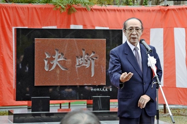生体肝移植手術から３０年を記念した碑文を前にあいさつする永末直文さん＝２０１９年１１月、出雲市塩冶町、島根大医学部