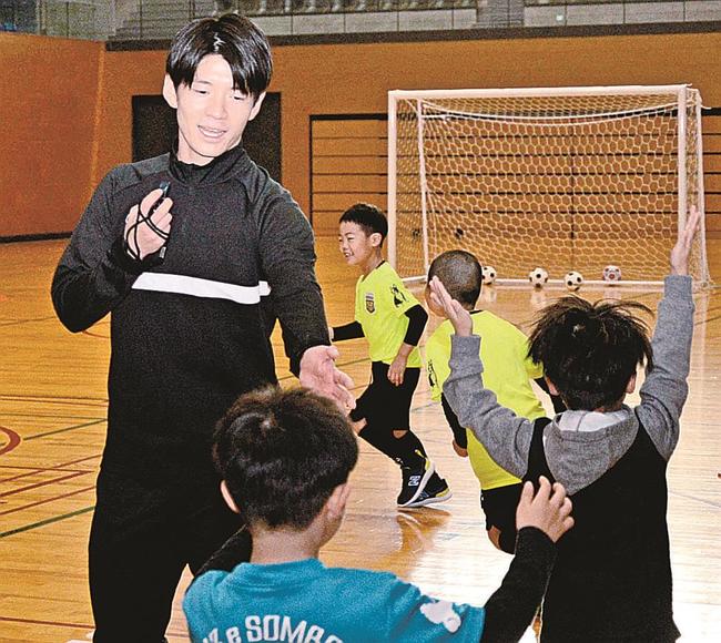 スクールの体験会で子どもたちを指導をする佐藤啓志郎さん（左）＝松江市学園南１丁目、市総合体育館