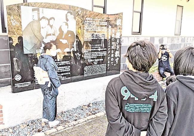 加納佳世子名誉館長（左）から莞蕾の平和活動を教わる児童＝安来市広瀬町布部、市加納美術館