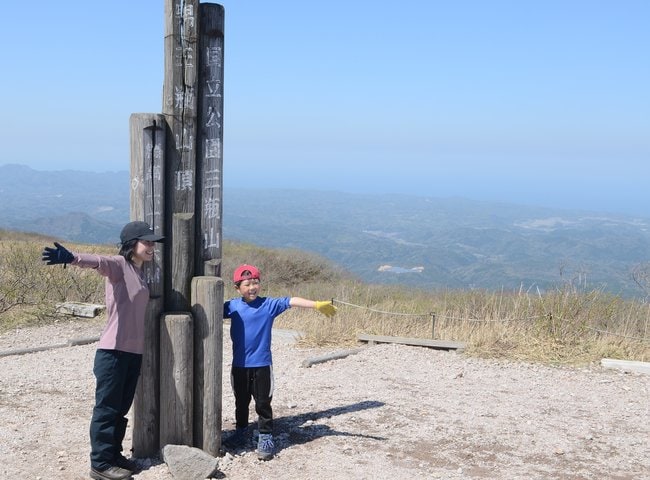 山頂でポーズを取る登山客