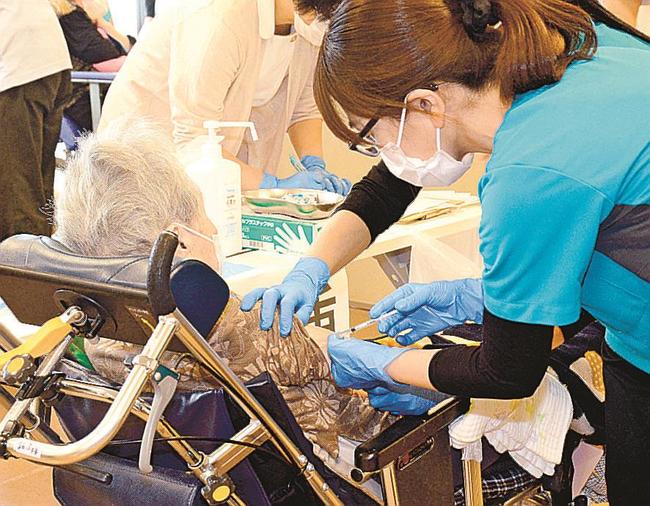 ワクチン接種を受ける入所者（左）＝松江市西浜佐陀町、特別養護老人ホーム明翔苑（代表撮影）