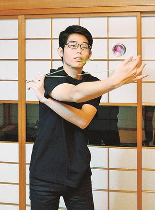 自分が設計し、商品化したヨーヨーで技を披露する吾郷雄飛さん＝出雲市内