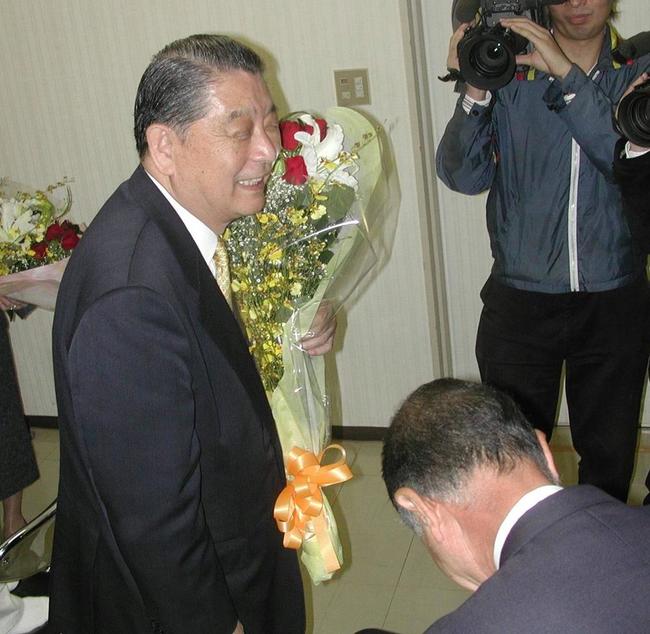 政界引退を表明し、花束を手に自民党関係者と言葉を交わす平林鴻三氏（左）＝２００３年11月10日、鳥取市内