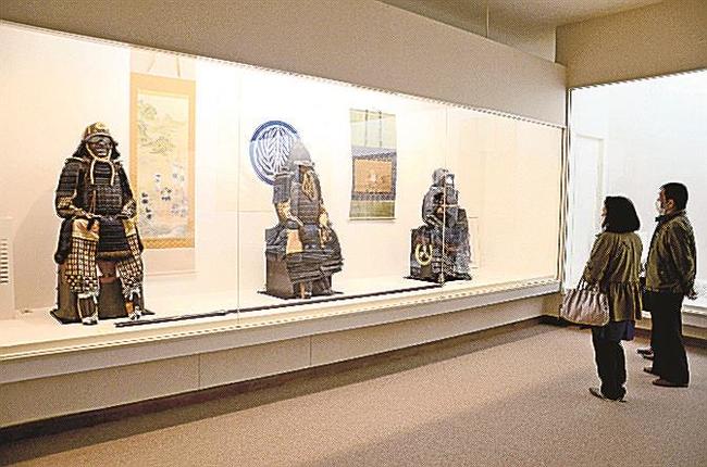甲冑に見入る来場者＝島根県奥出雲町上阿井、可部屋集成館