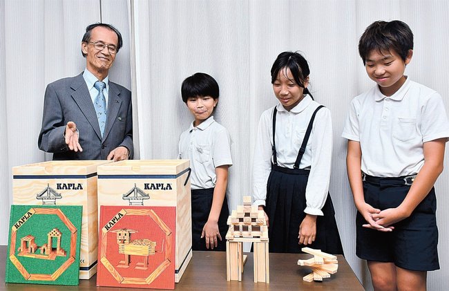 小学生に「ＫＡＰＬＡブロック」について説明する竹本博志さん（左端）＝浜田市殿町、市役所