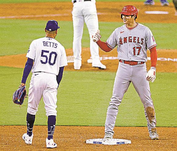 ドジャースのベッツ選手（左）と言葉を交わす大谷翔平選手。来季は青色のユニホームに袖を通す＝７月、ロサンゼルス（共同）