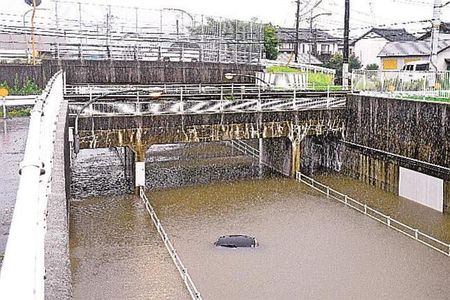 アンダーパスに水没した軽乗用車＝７月９日午後３時４５分、出雲市斐川町直江