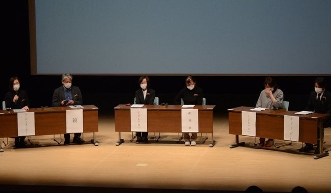 桑原正好代表（左）の進行で、体験発表する遺族５人＝安来市飯島町、アルテピア
