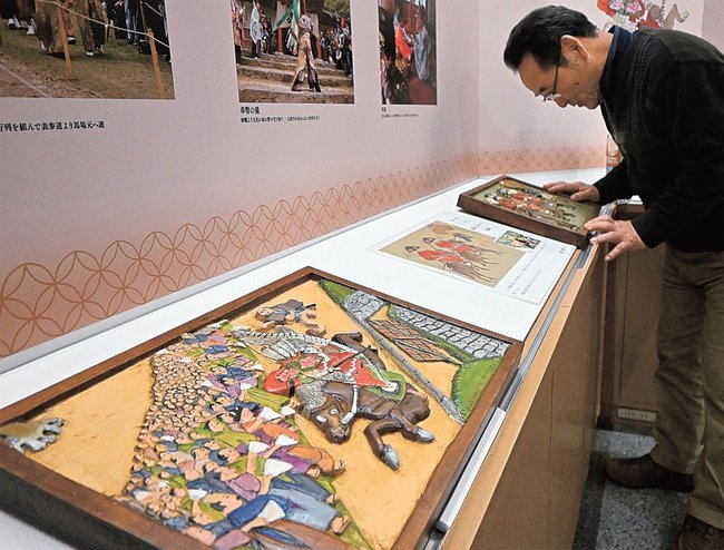 津和野百景図を題材にした木彫り作品を見るスタッフ=島根県津和野町後田、町日本遺産センター