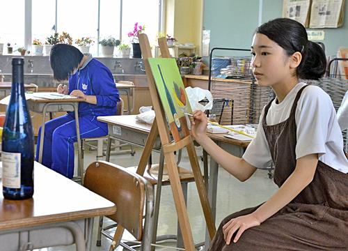 美術部の後輩（左奥）とともに、作品作りに励む小原乙華さん＝鳥取県大山町所子、大山中学校