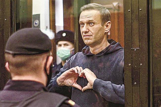 公判中にハートマークをつくるナワリヌイ氏。モスクワの裁判所が２０２１年２月に映像を提供した（ＡＰ＝共同）