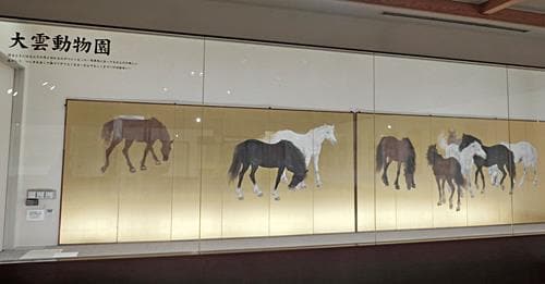 大正天皇の御物となった馬を９頭描いた作品と同じ構図で、小村大雲展「大雲動物園」に展示されている金屏風＝出雲市平田町の平田本陣記念館
