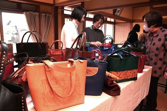 手作りのかばんに見入る来場者たち＝出雲市荒茅町